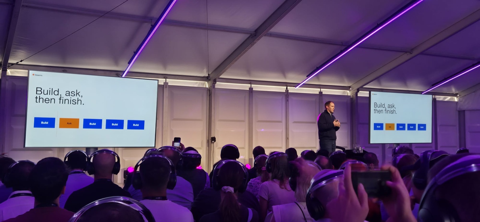 Matt Bauman presenting the build, ask, then finish slide at World Summit AI